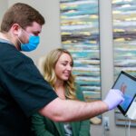 Dr. Seth R. Brooks Showing Patient a Digital Impression